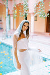 Model wears a wedding veil, one tier veil with pearls and sequins