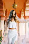 Model wears a floral wedding veil, one tier veil with pearls and fabric flowers.