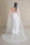 Model wears a floral wedding veil, one tier veil with pearls and fabric flowers.