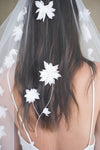 Model wears a floral wedding veil, one tier veil with fabric flowers.