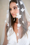 Model wears a floral wedding veil, one tier veil with fabric flowers.