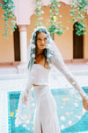 Model wears a floral wedding veil, one tier veil with fabric flowers.