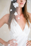 Model wears a floral wedding veil, one tier veil with fabric flowers.