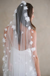 Model wears a floral wedding veil, one tier veil with fabric flowers.