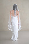 Model wears a floral wedding veil, one tier veil with fabric flowers.