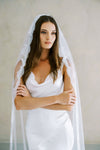 Model wears a lace wedding veil, one tier veil with lace trim.