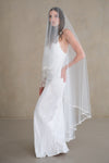 Model wears a pearl wedding veil, drop veil with pearls.