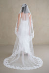 Model wears a lace wedding veil, Mantilla veil with lace trim.