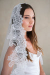 Model wears a lace wedding veil, Mantilla veil with lace trim.