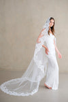 Model wears a lace wedding veil, Mantilla veil with lace trim.