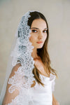 Model wears a lace wedding veil, Mantilla veil with lace trim.