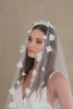 Model wears a floral wedding veil, one tier veil with fabric flowers.